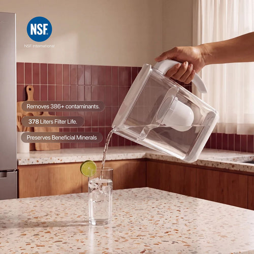 Norde Filtered Water Pitcher pouring a glass of water in a kitchen